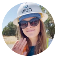 Jenna wears a hard hat and visits a job site